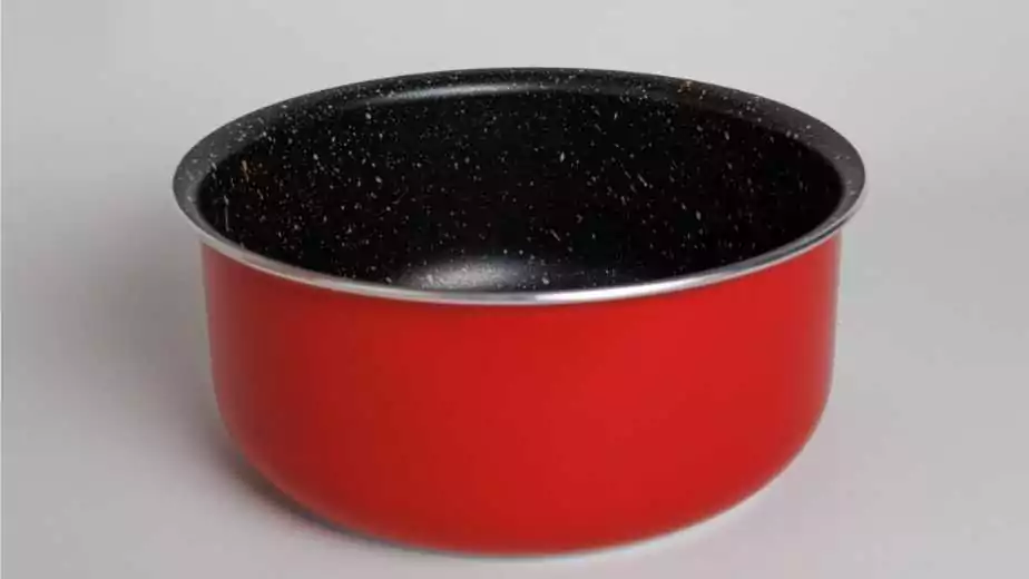 frying pan made from red ceramic with a white background