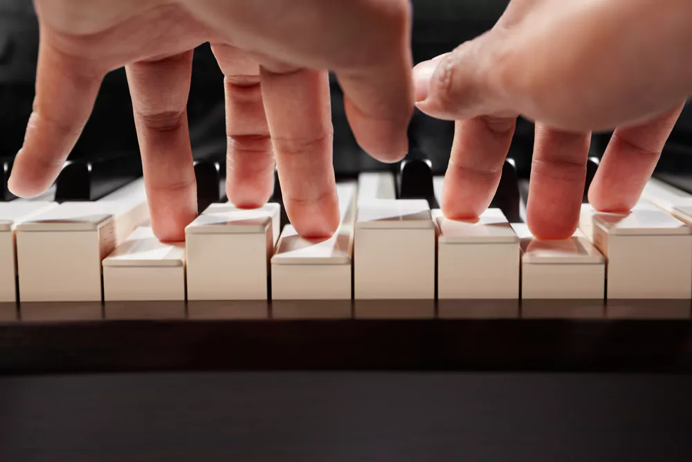 fingers playing piano keys
