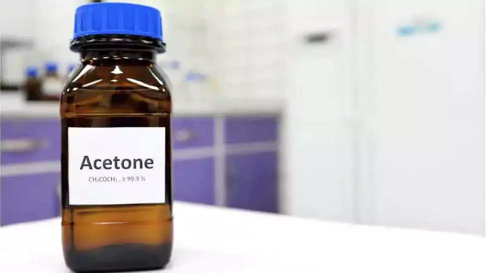pure acetone solution in brown glass amber bottle inside a chemistry laboratory