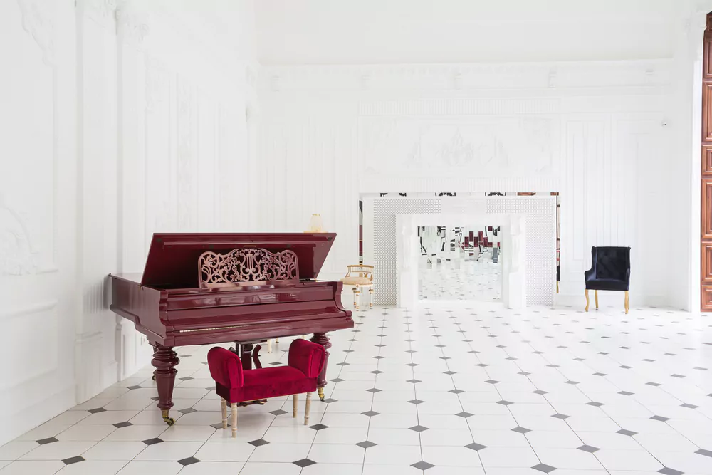 huge luxury white hall with unique interior an a grand piano