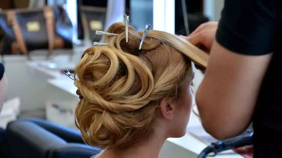 hair dresser doing hair of a woman