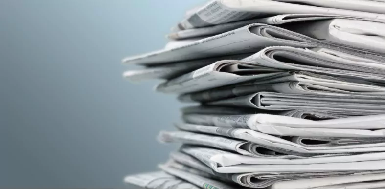 pile of newspapers on white background