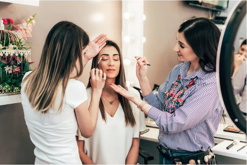 professional makeup artist teaching students in makeup school