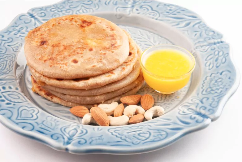 puran poli with ghee butter served in a plate
