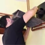 man cleaning chimney at home
