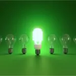 energy saving and simple light bulbs isolated on green background