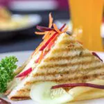 vegetable jumbo grilled sandwich served with french fries club sandwich with tomato cucumber beetroot and onion