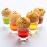 pani puri shot or golgappa shots different flavors of water served in small glasses with stuffed puri