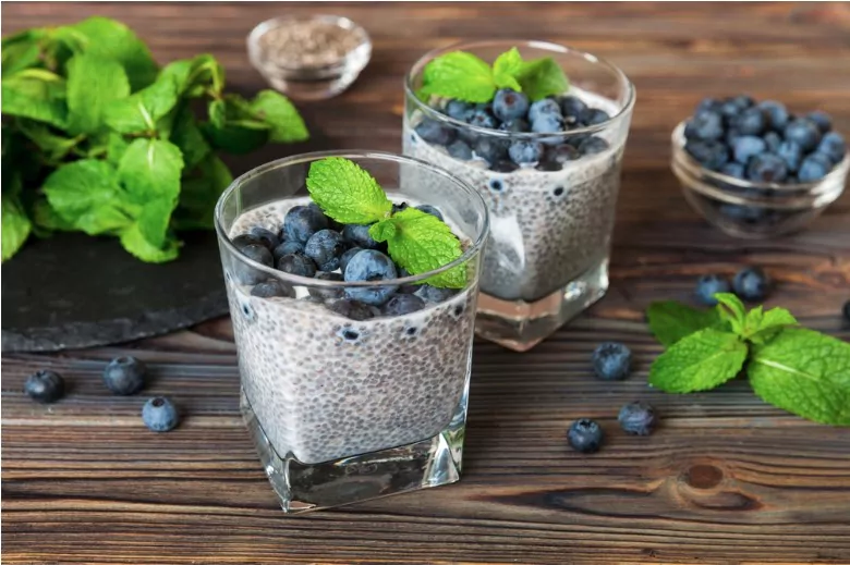 healthy breakfast or morning with chia seeds vanilla pudding and blueberry berries on table background