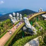 aerial view of the golden bridge is lifted by two giant hands in the tourist resort on Ba na hill in da nang vietnam