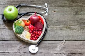 healthy food in heart and cholesterol diet concept on vintage boards