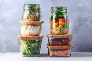glass boxes and cans with fresh food refrigerator storage concept
