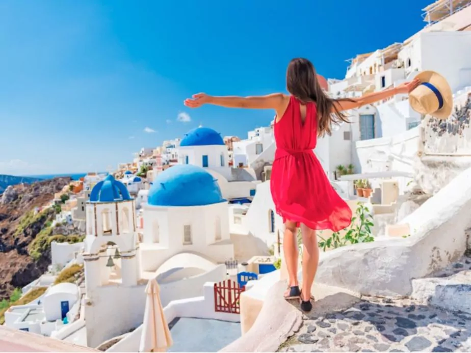 carefree girl tourist in european destination wearing red fashion dress