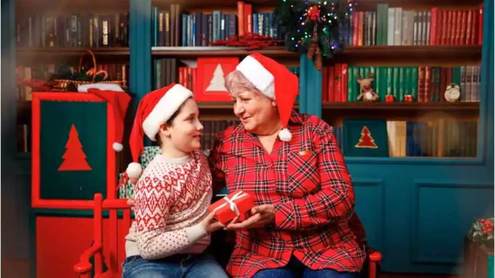 loving grandma enjoying time with his grandson decorating christmas tree