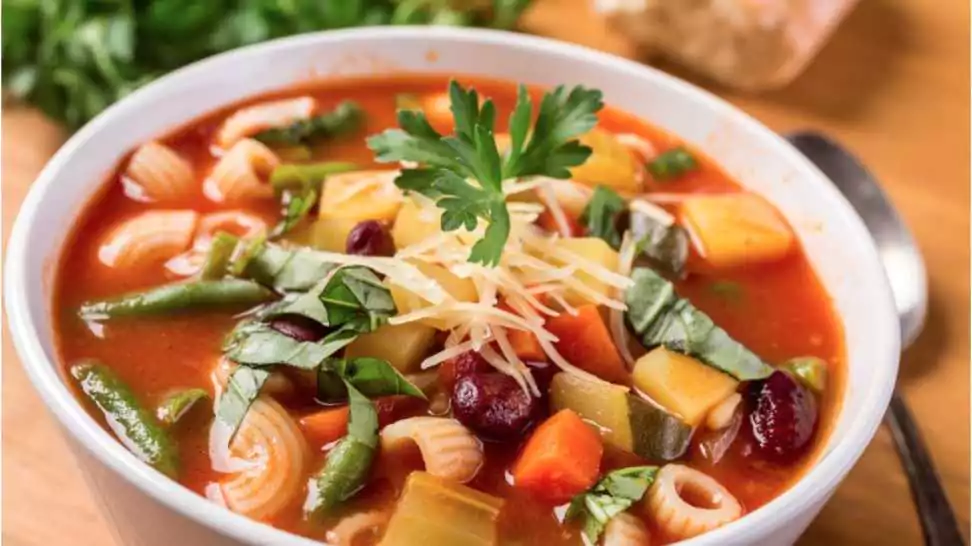 bowl of minestrone soup with pasta beans and vegetables