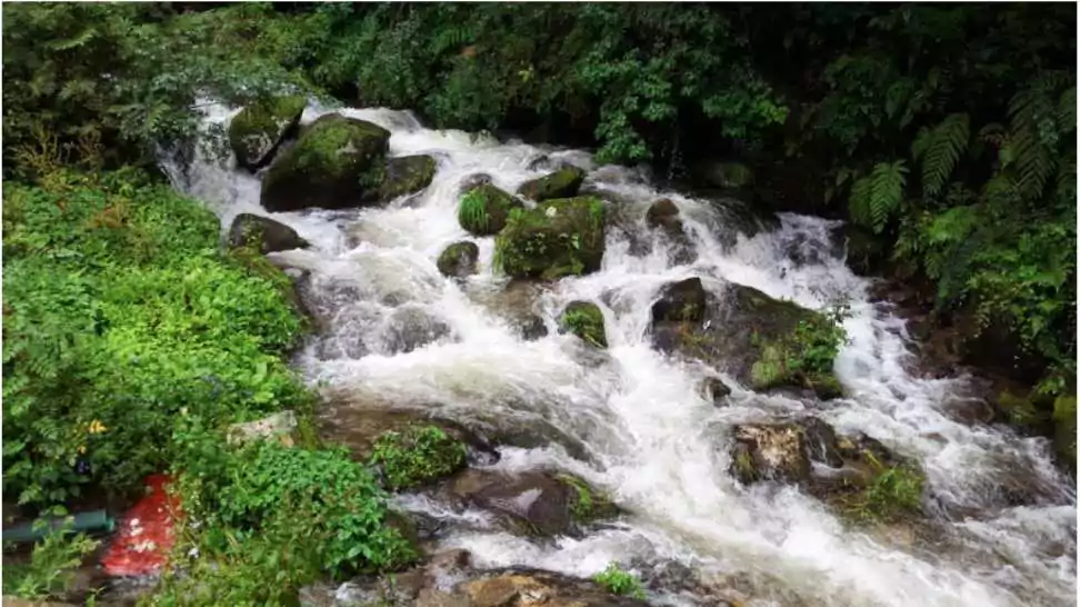 water flows beautifully from jogini waterfalls in manali india