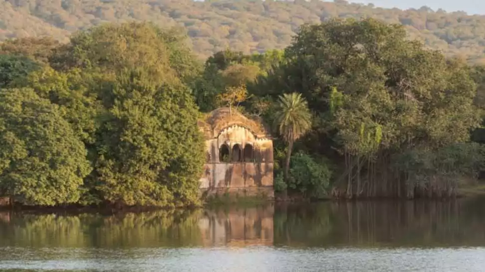 the view of raj bagh ruins with reflection on water