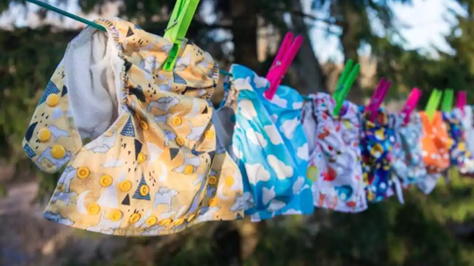 reusable baby diapers in front of a nature background and blue sky