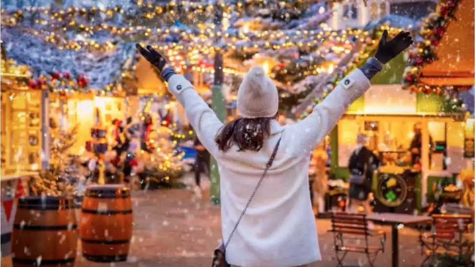 a happy tourist woman stands on a winter market