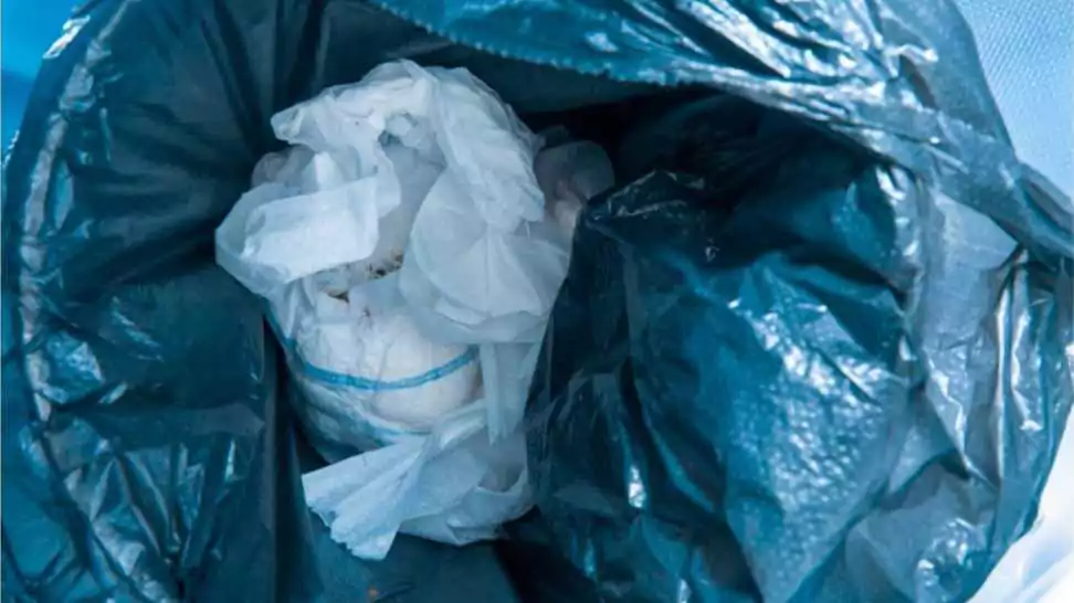 waste used children's dirty diaper garbage in the trash bin