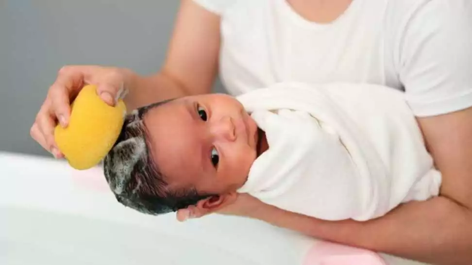bathing a baby with a sponge