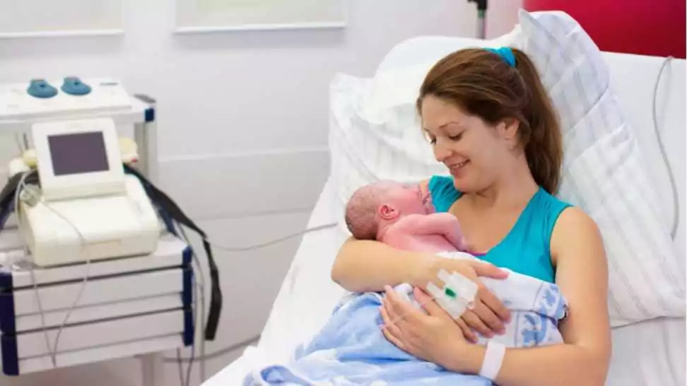 mother giving birth to a baby newborn baby in delivery room