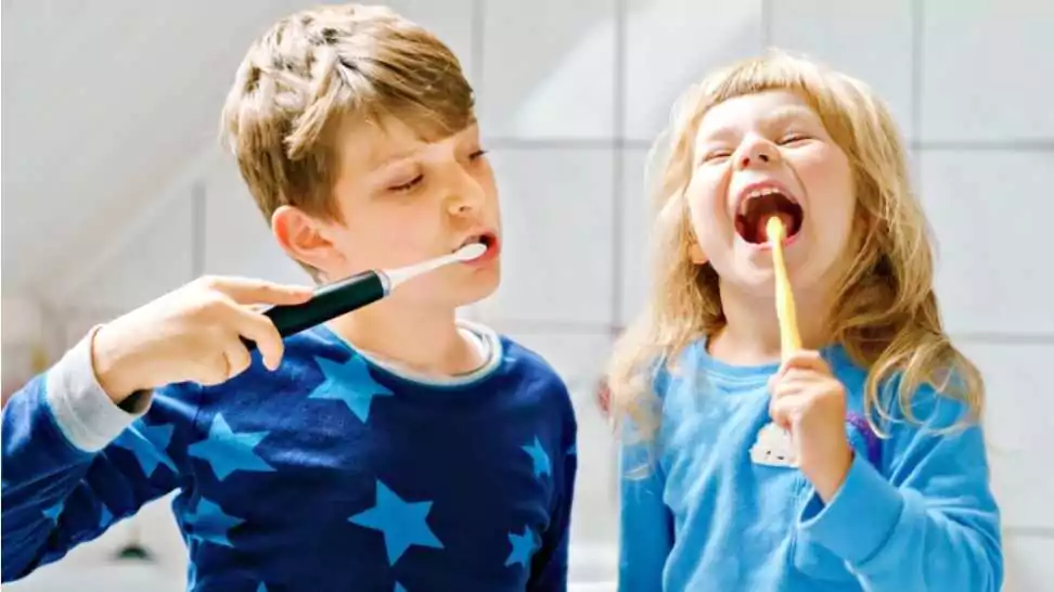 little preschool girl and preteen school boy brushing teeth