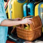 image of man packing picnic basket at car trunk