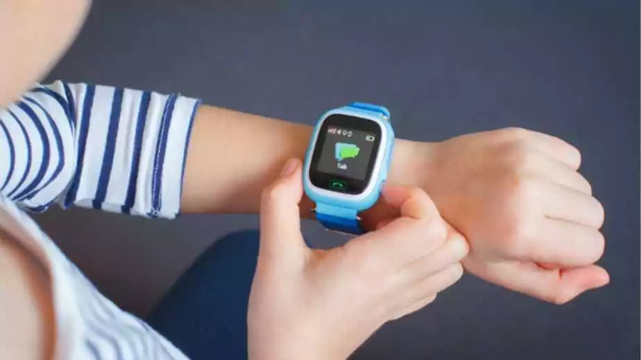 a little girl wearing a smartwatch oh her wrist