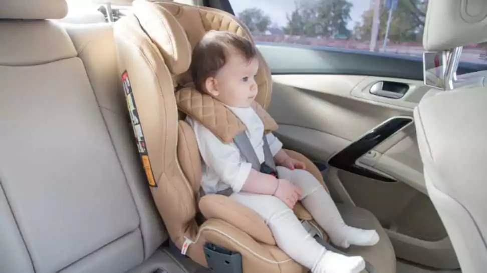 child in a baby car seat