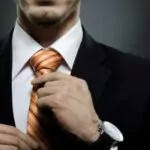 businessman in black costume wearing an orange tie