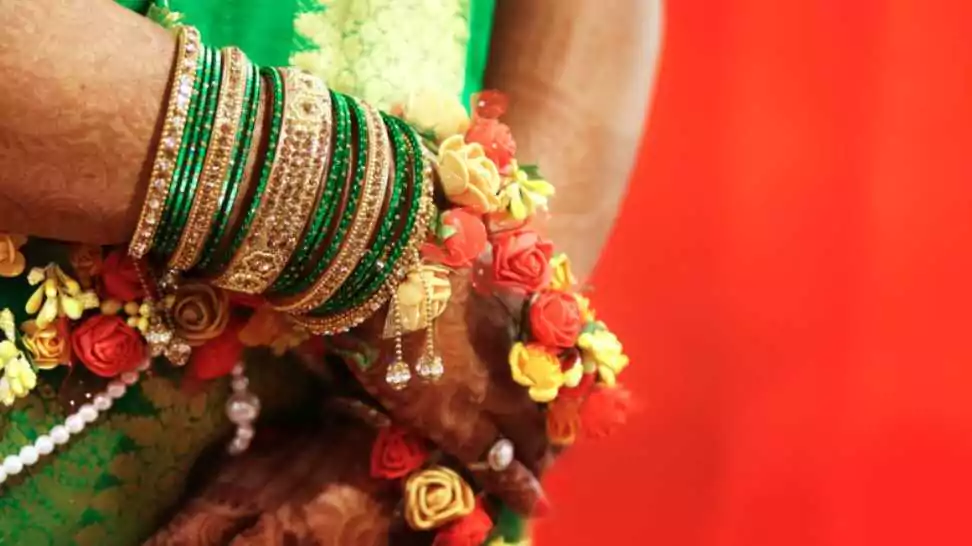 woman wearing bangles at valaikappu an indian baby shower function