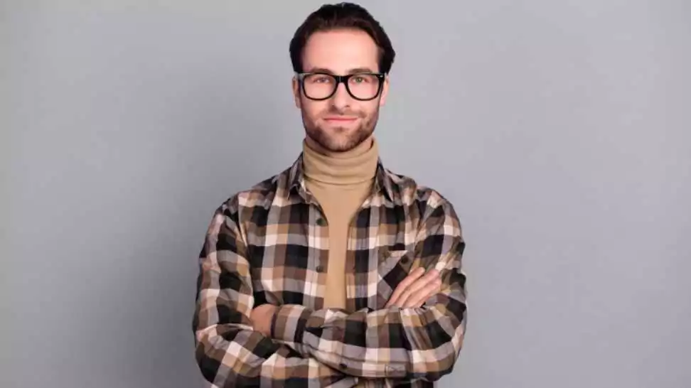 photo of clever charming man wearing plaid shirt with a turtleneck