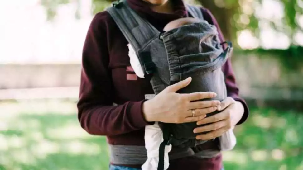 father with little baby in a sling