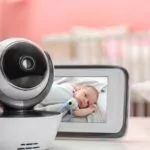 modern security cctv camera and monitor with baby's image on table