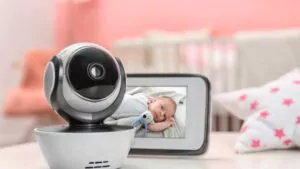 modern security cctv camera and monitor with baby's image on table