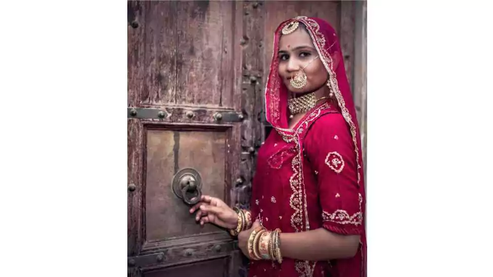 stunning indian bride dressed in hindu (rajput) traditional wedding clothes