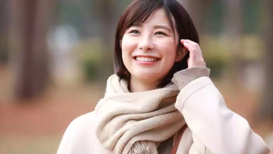 image of a smiling woman wearing muffler