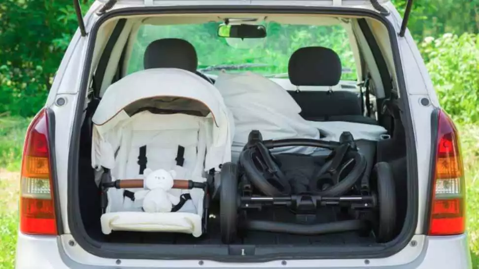 parts of baby stroller in opened car trunk