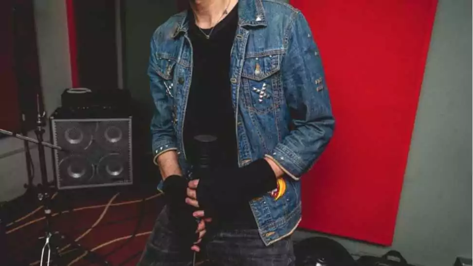 young rocker vocalist wearing raw denim jacket