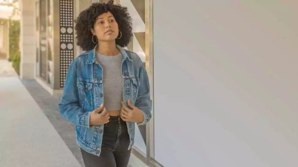 a casually dressed confident woman wearing denim jacket with leggings