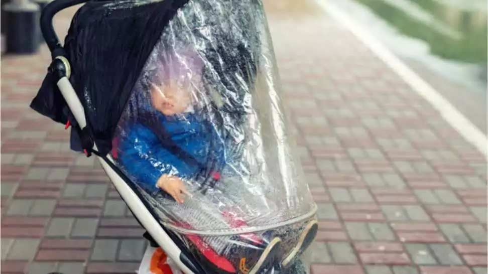 child sitting in an umbrella stroller