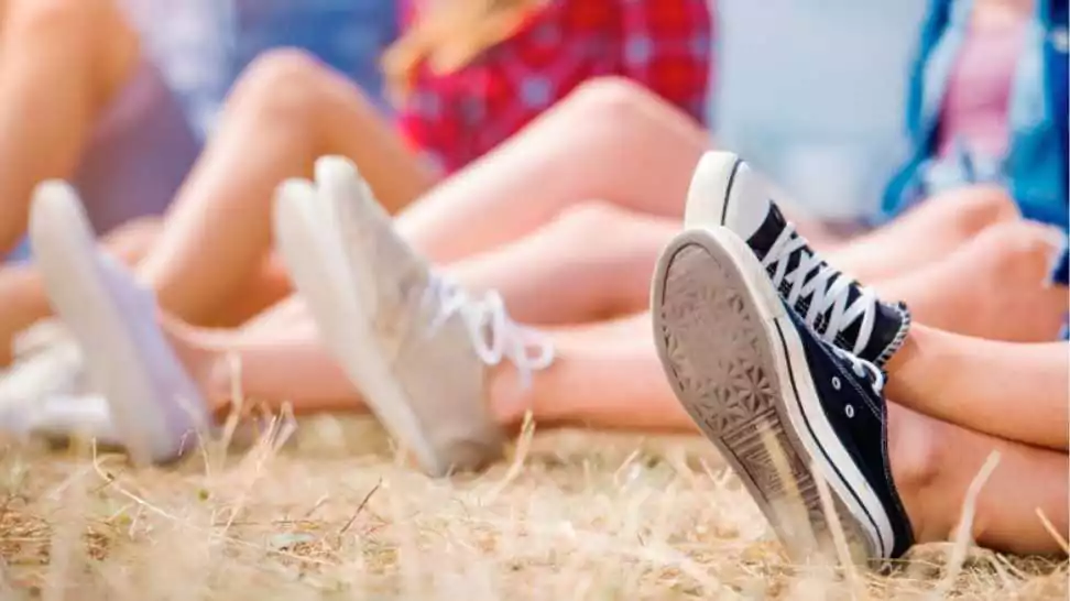 young teens at summer music festival wearing canvas shoes