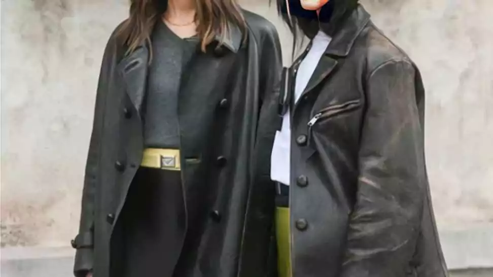 women wearing a grey sweater black mini skirt black leather jacket