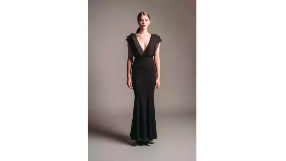 elegant lady in full length sleeveless gown with deep v neckline