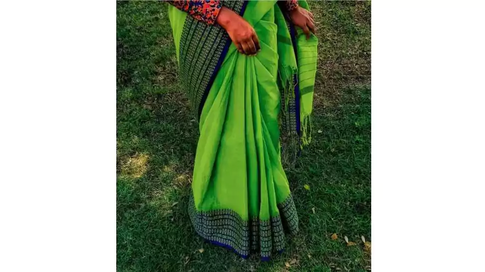 a young bengali lady manages her elegant green saree pleats