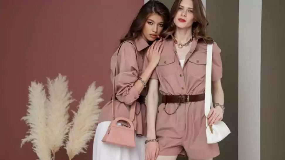 two fashion models in rosy brown looks jumpsuit shirt cream white long skirt handbag