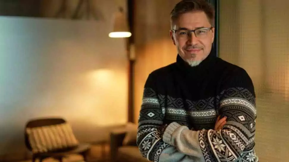 happy man at home in scandinavian turtleneck sweater